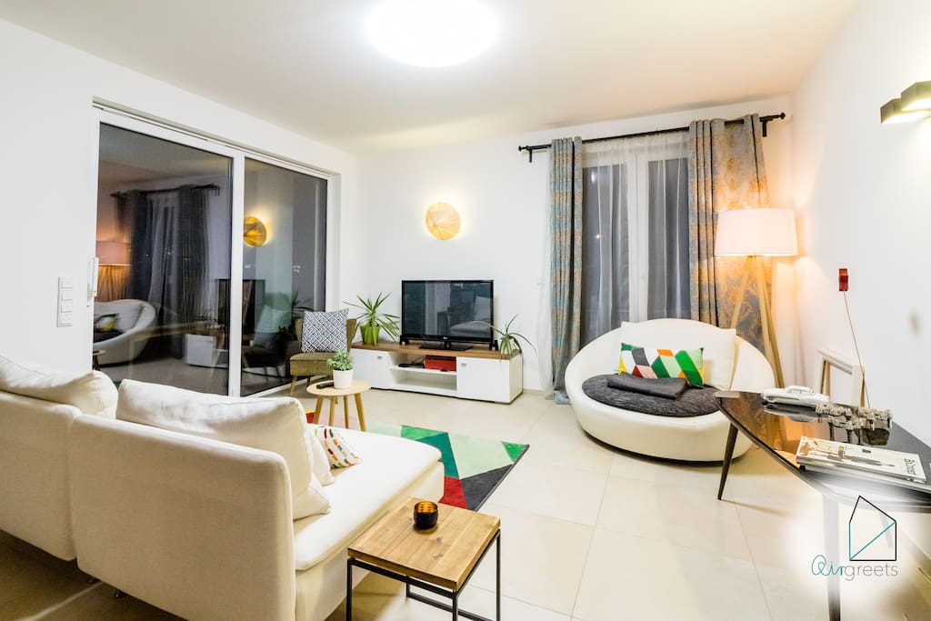 Bright & cozy living area with creative decor and modern TV