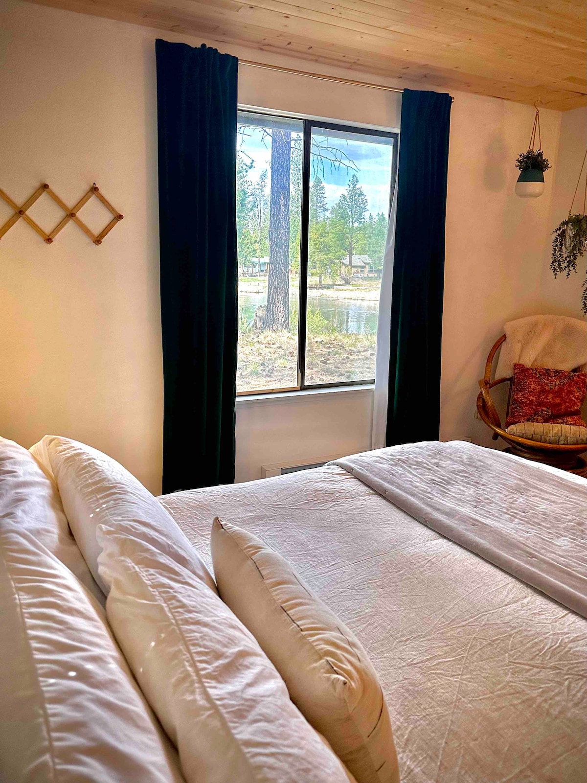 Primary bedroom with king bed and Deschutes River view.