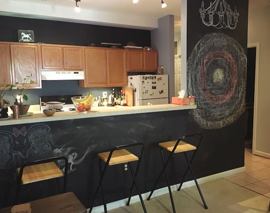 Breakfast bar and chalkboard wall, view from living room.