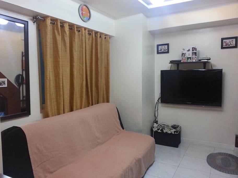 The living room with sofa bed and flat screen LCD TV.