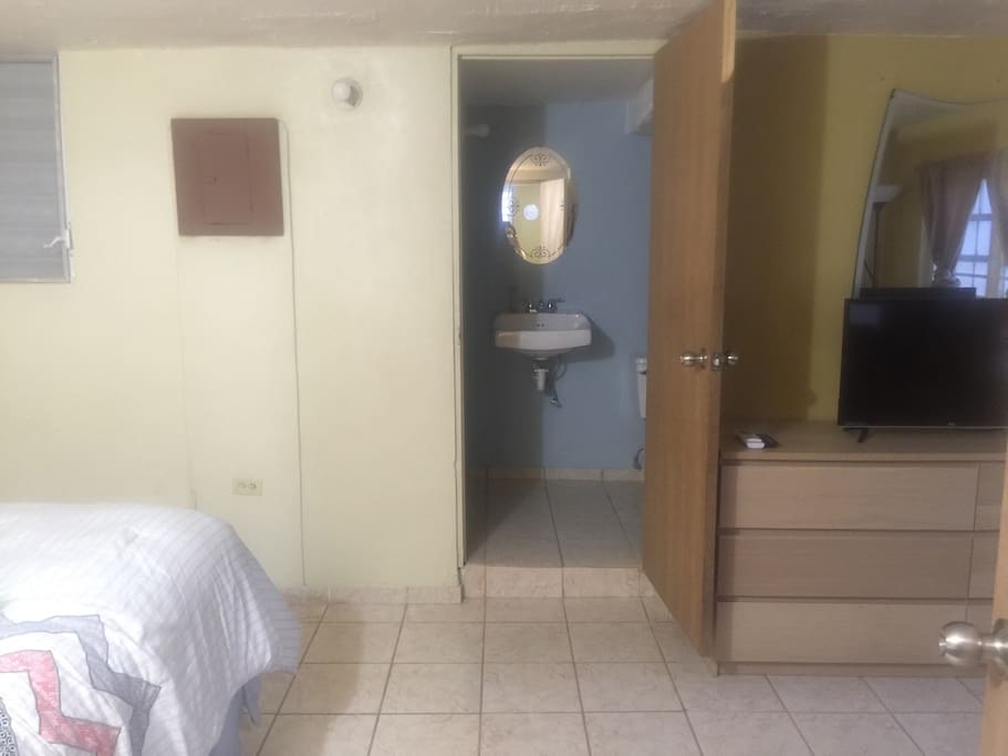 The entrance to the room! It has AC, wifi, tv a king size bed, and a small sofa!