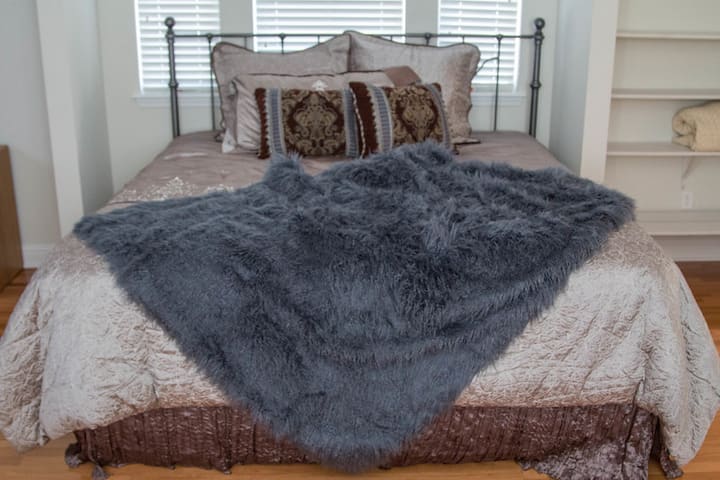Upstairs large bedroom with king size bed, work station, and twin bed