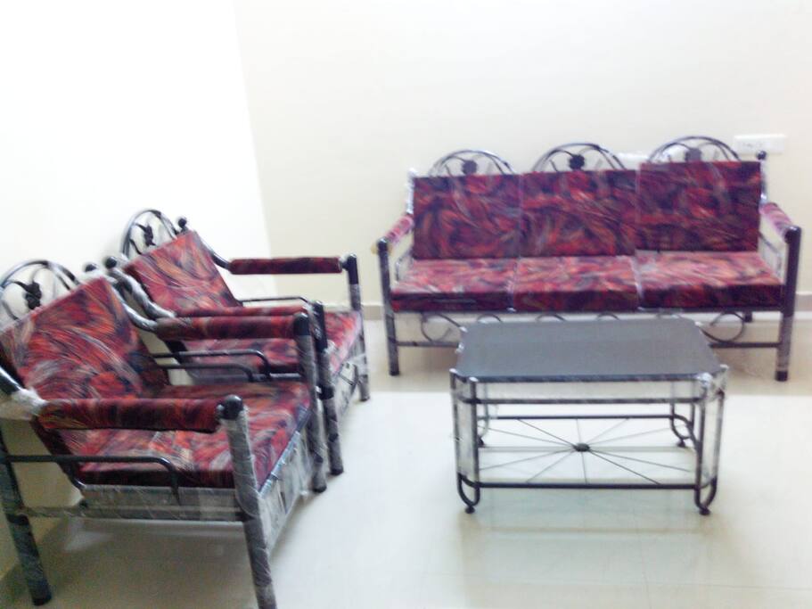 Living room (left hand side) - 3 sofas and one table.