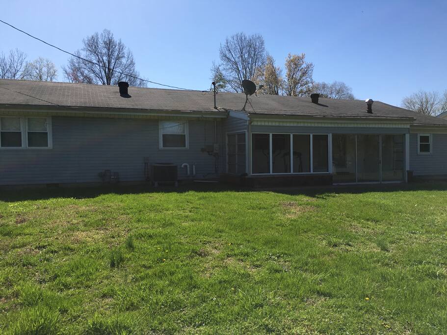Back of property featuring screened in back porch