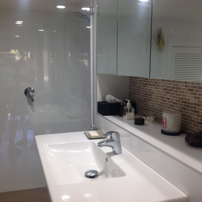 Modern bathroom with shower and large bath.