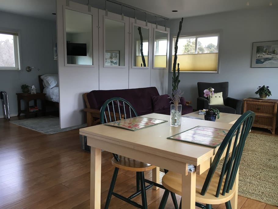 Looking back toward the living area and bedroom from the kitchen area. Note the custom suspended room divider accent (really cool and semi-private from the bedroom). The table expands 18" on both ends; ample workspace for business travelers.