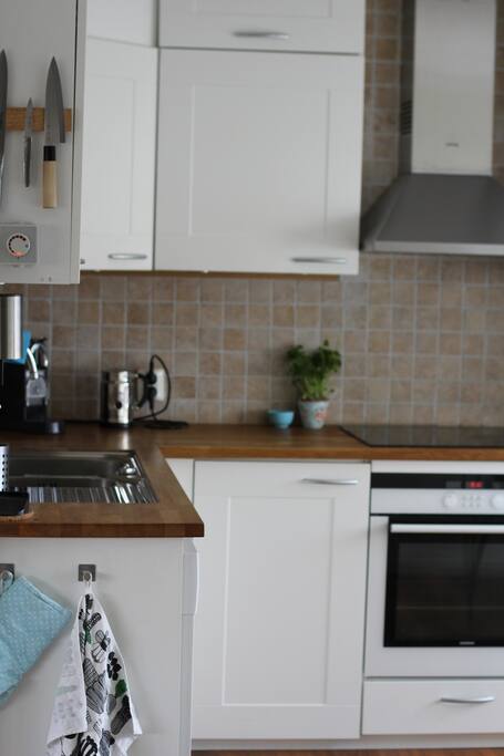 Kitchen, dish washer, owen, stove, fridge, freezer, coffey machine, soda streamer. Table with space for four people.