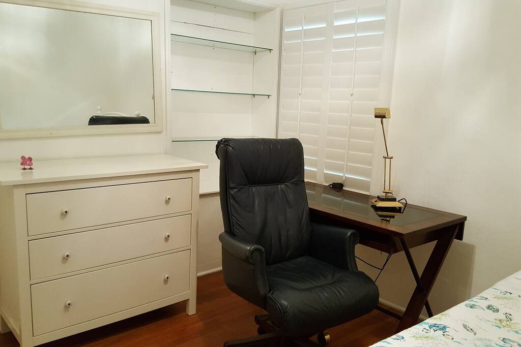 bedroom #1 with built in bookshelf and leather chair computer desk and drawer