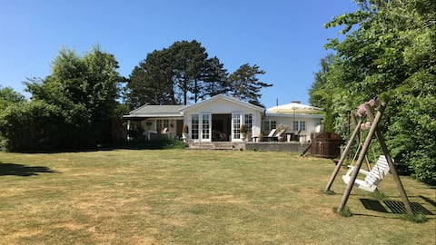 Large cottage close to water and city.