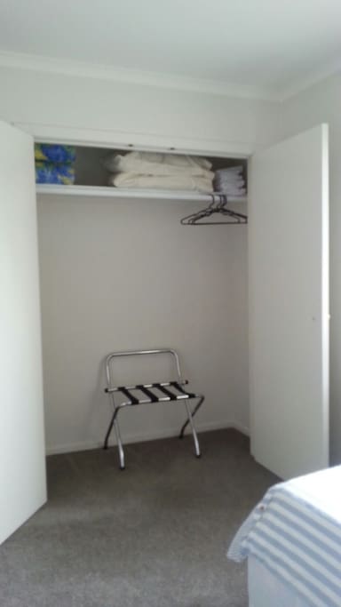 Wardrobe with luggage rack....saves bending. Spare pillows and quilts