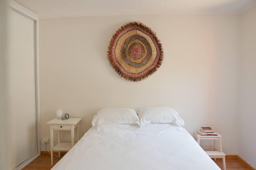 Uncluttered bedroom with queen sized bed.