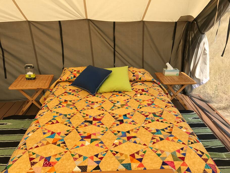 Inside, you'll find a queen sized bed with cotton sheets and a handmade summer quilt.