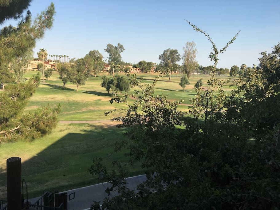 Balcony looks over golfcourse and a 21 mile bike trail is at the base of the steps to the unit.