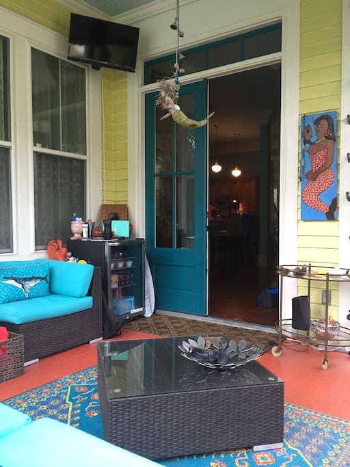 Reverse view of porch with outdoor TV and fridge. Just beautiful at night with hanging lights, music.