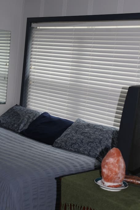 TV, DVD player, Spectrum Cable on top of dresser, mirror on the wall, window to back deck area