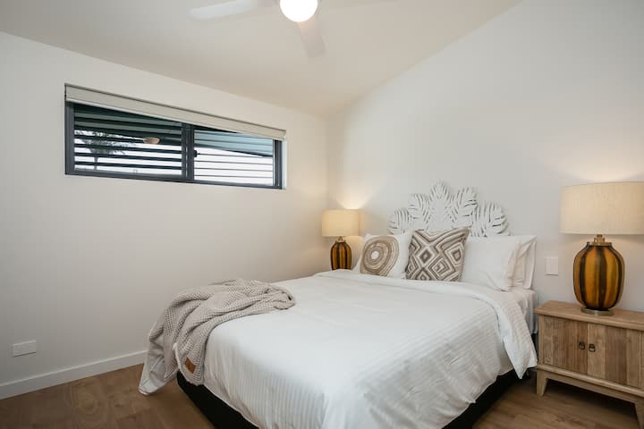 Main bedroom has a queen bed and ensuite bathroom including a bath.