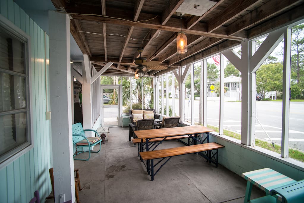 Screened porch with table & lots of seating.