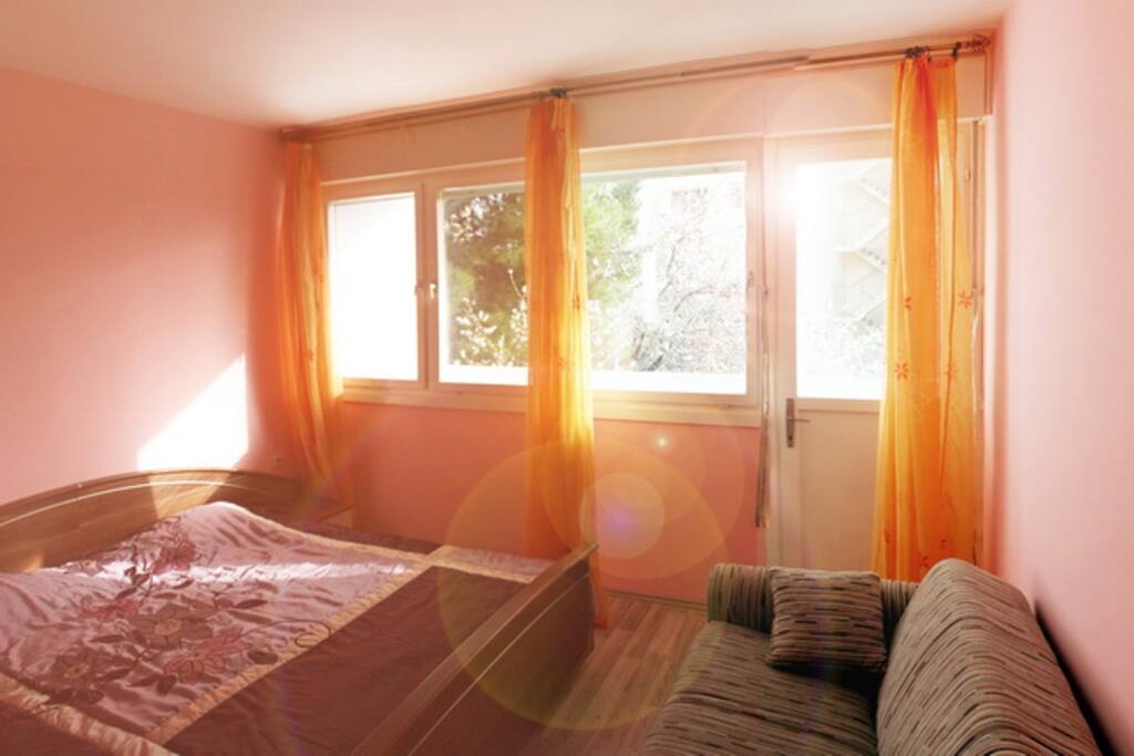 Bedroom with view and entrance to balcony.