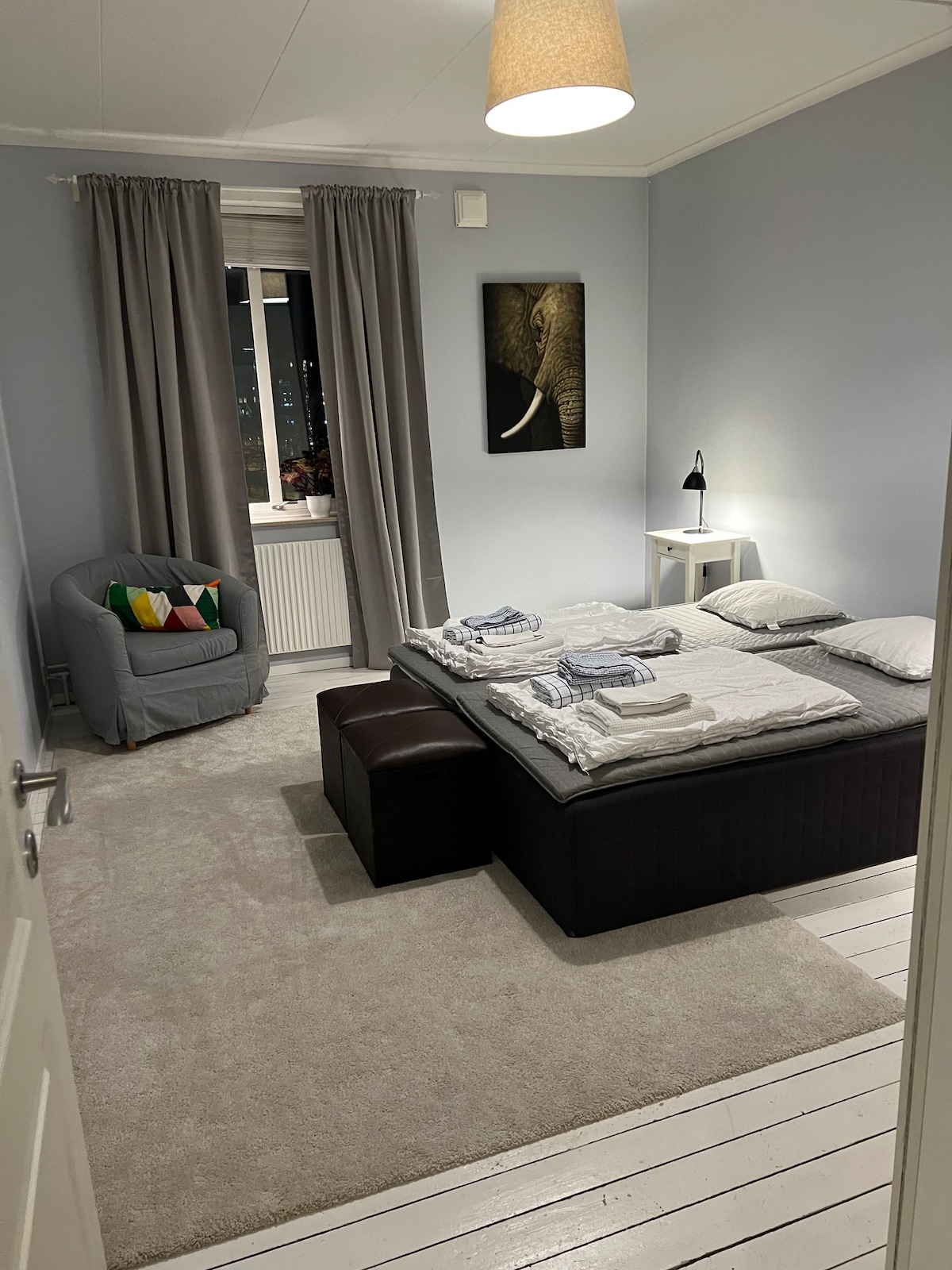 The light master bedroom with a double bed, perfect for two adults.
