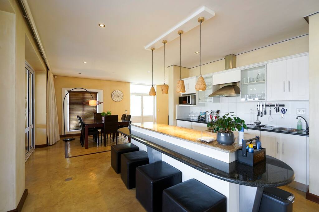 wide angle shot of bar counter, cooking area and dining