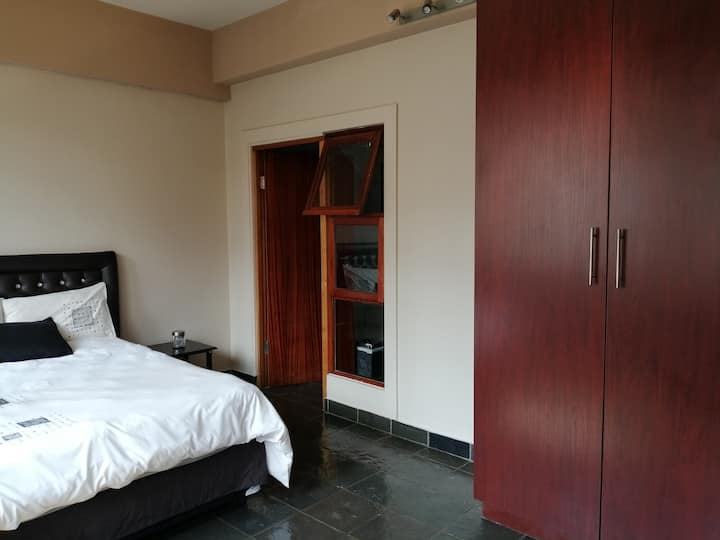 Cama queen en suite con ducha