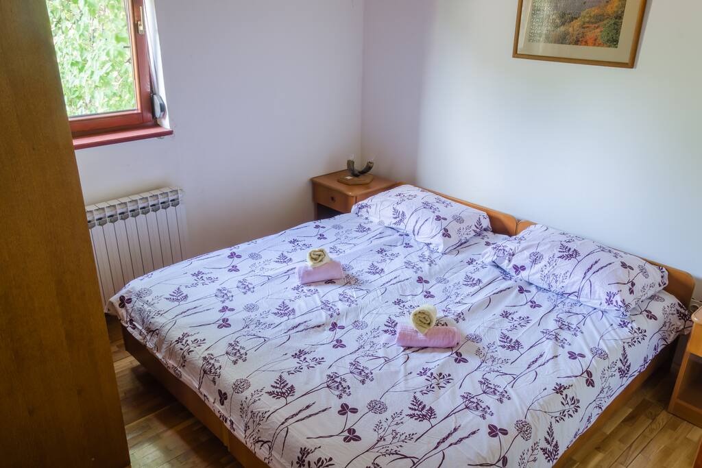 This is the larger bedroom with 2 twin-sized bed, which can be combined separately or together, closet for two and window that overlooks garden and the woods.