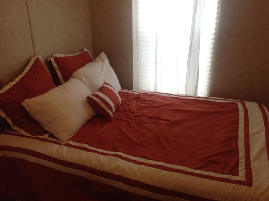 Master bedroom has double size bed.