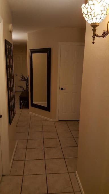 The room is the second door on the left of this hallway. The first door on the left is the bathroom.