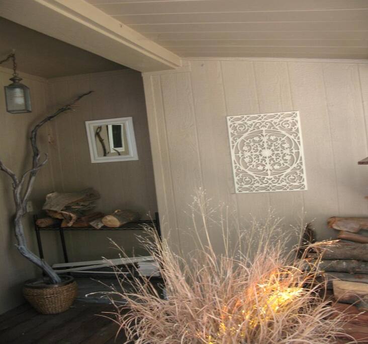 Covered front porch stocked with plenty of kindling and firewood