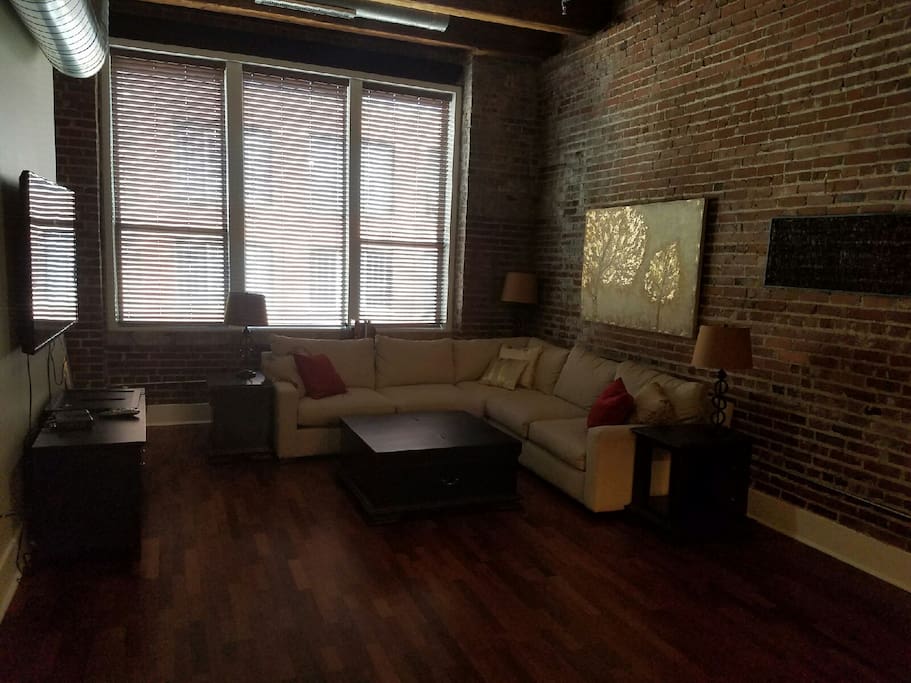 Living Room with 52" wall mounted cable television, DVD player, and a selection of book titles for your enjoyment.
