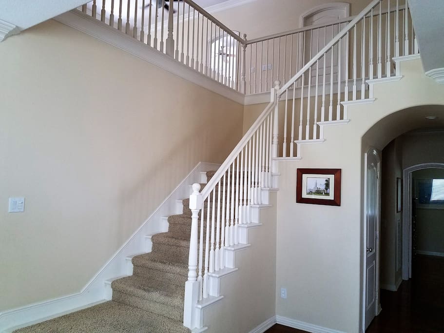 Stairs off entry way. You can see the doorway for bedroom one, at the front of the house.