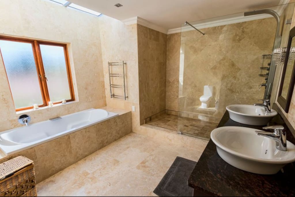 A truly luxurious bathroom with a skylight to the stars