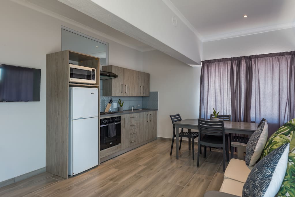 Kitchen with oven, hob and fridge and microwave