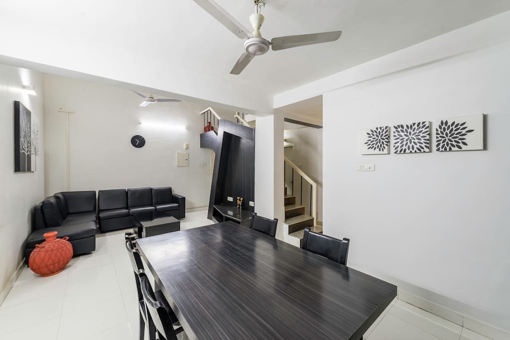 Living cum dining space with sofas and Dining table
