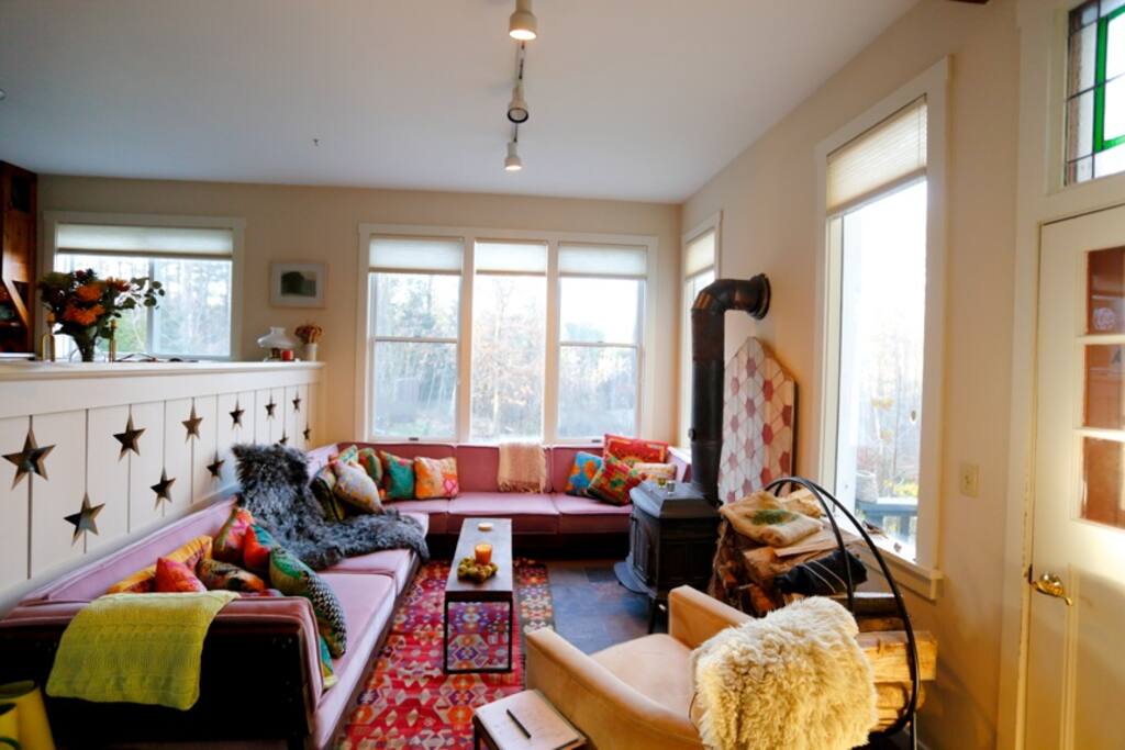 Comfy lower living area w wood stove and Moroccan couches