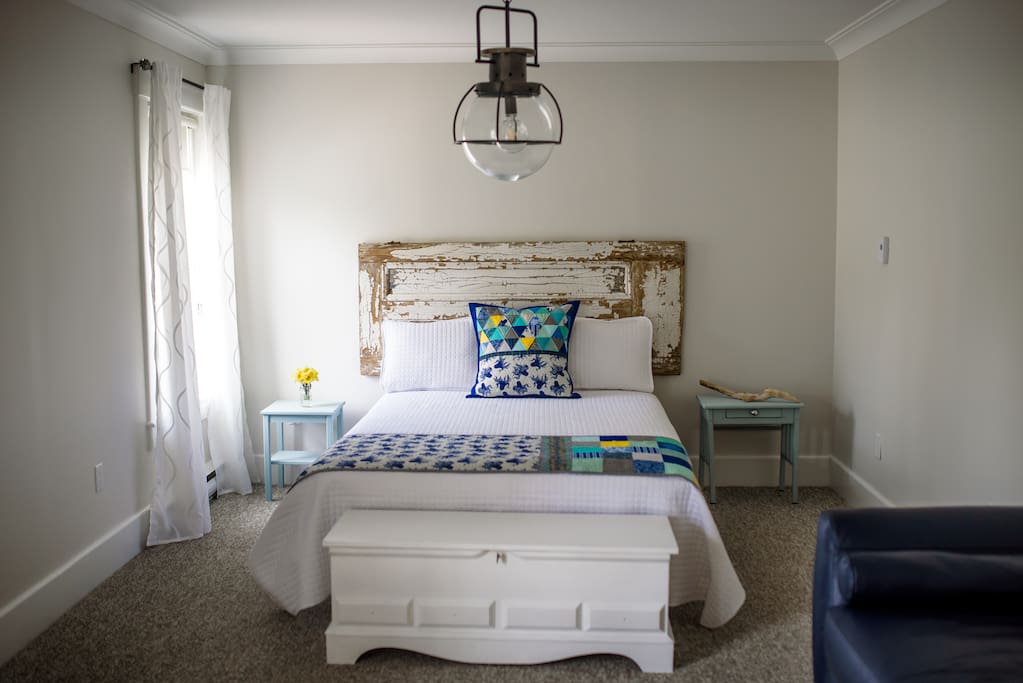 Comfy queen bed with custom Pillows and Bed Runner by local textile artist Valerie Levy.