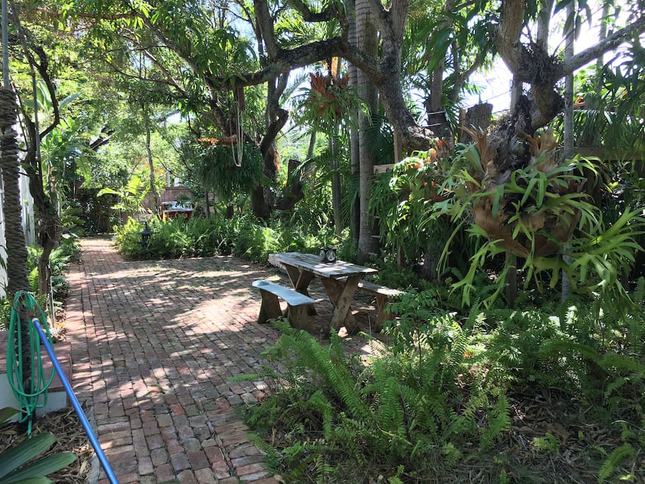 lushly landscaped yard w/ tropical plants & trees surrounding you w/ privacy