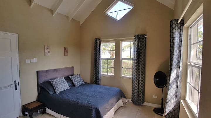 Master bedroom with air-con, fan, walk-in wardrobe and en suite