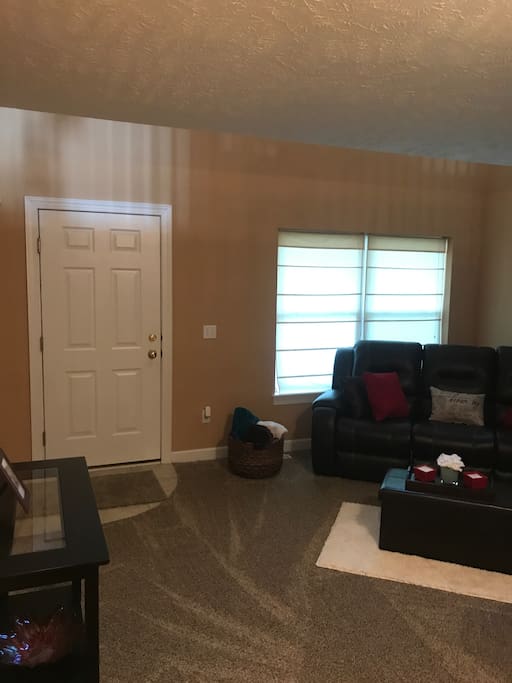 Living room area includes a leather reclining sofa, reading nook, and brand new board games. Monopoly, cards, uno, bingo, family feud, chess, Yahtzee.