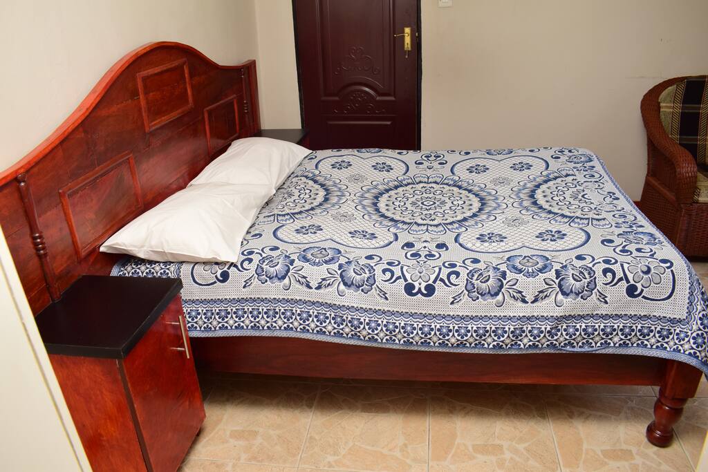 Side view of double bed with hardwood headboard