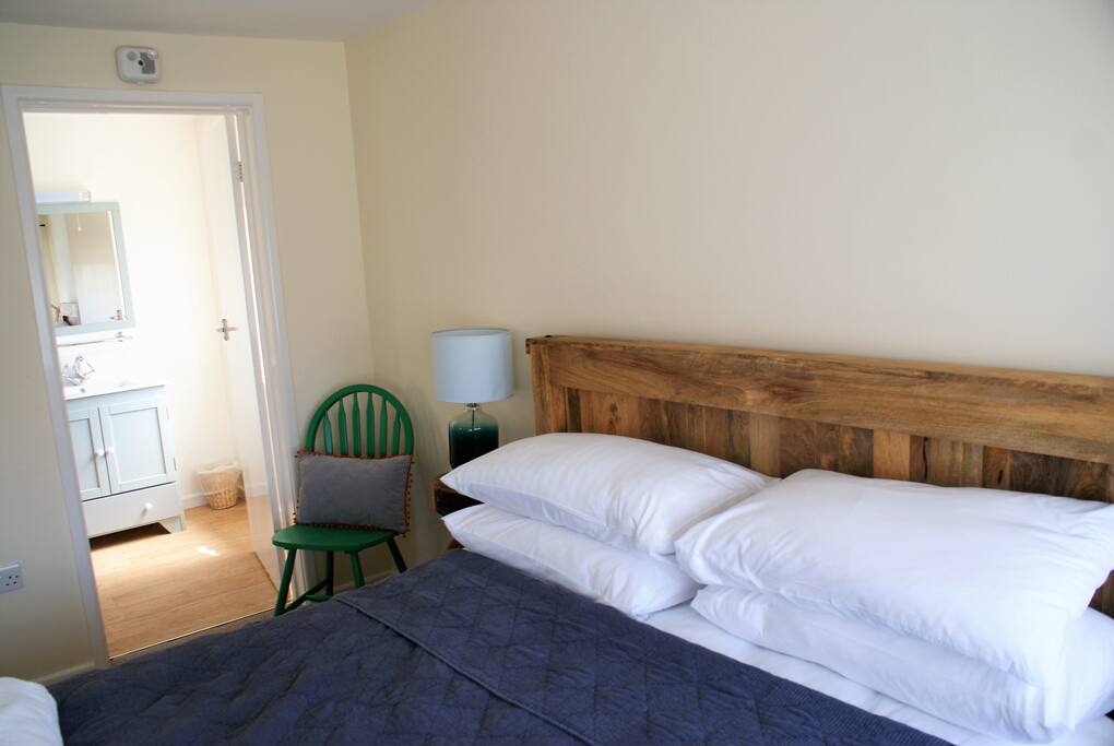 Main double bedroom with chest of drawers, wardrobe and ensuite bathroom