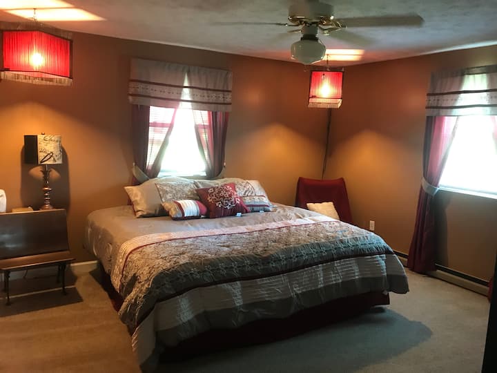 Beautiful and relaxing master bedroom with a King Size bed and 40"  TV with Roku access.  Pull out Futon sleeps an additional person for a total of 3.
