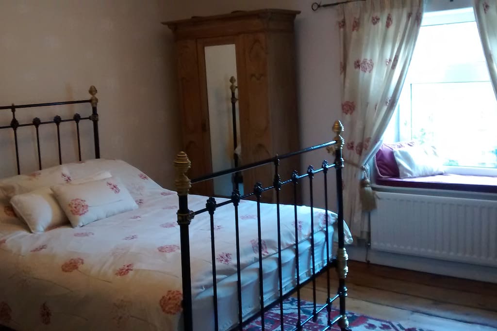 Master bedroom with Victorian cast iron double bed and period furnture