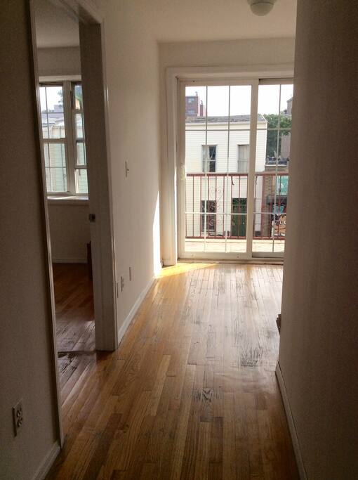 Living room area now has a table, chairs and a balcony.