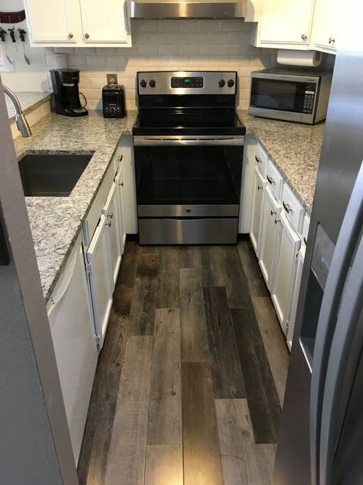 Beautifully updated kitchen with granite counter tops and stainless steel appliances.