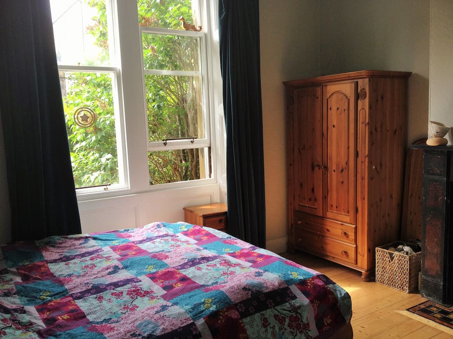 There is plenty of clothes storage in the antique pine wardrobe.