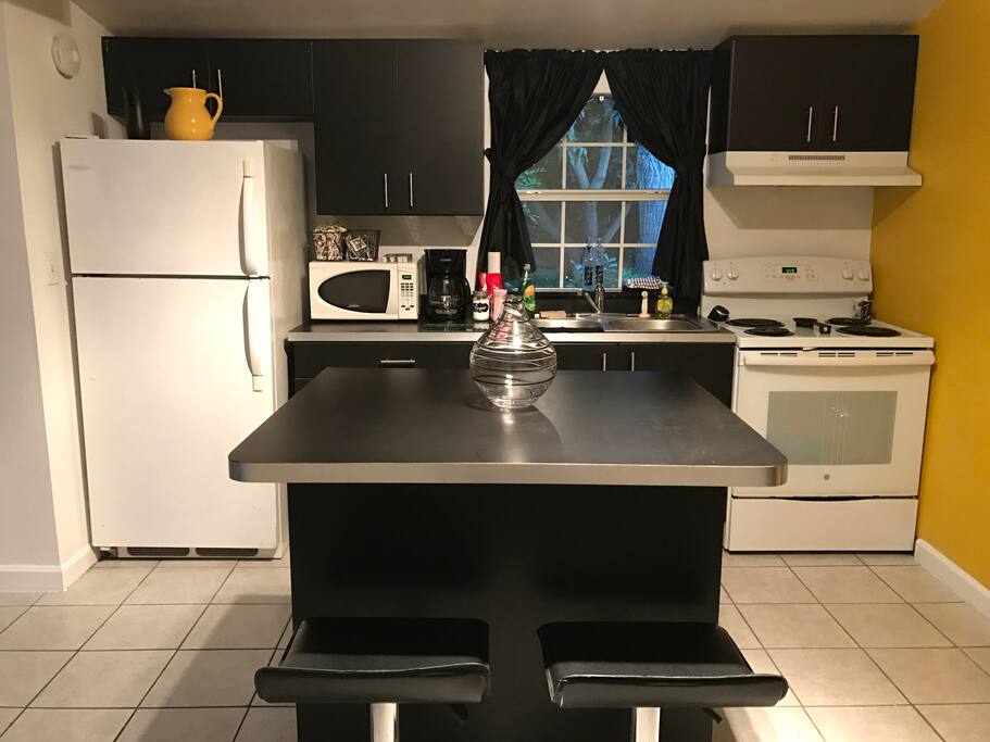 The kitchen is fully stocked with utensils, pots, pans, and appliances.