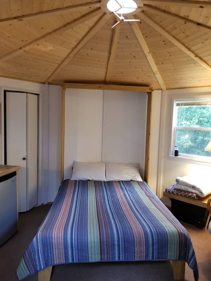 Queen size Murphy style bed with real mattress, ready for a cozy nap or a peaceful night's rest