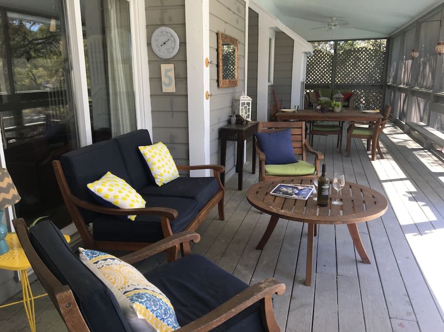 Back deck perfect for entertaining, with a seating area and dining table.