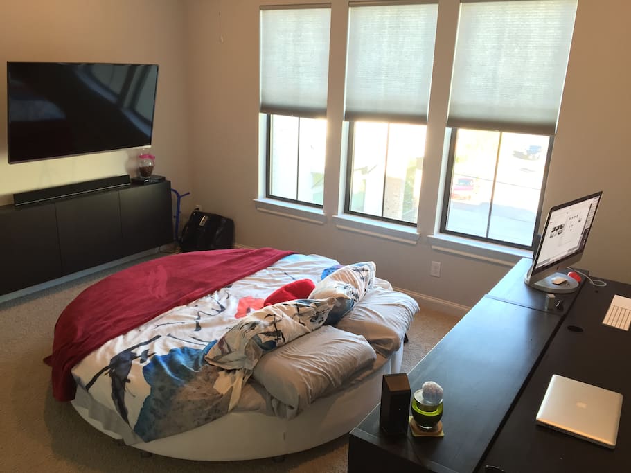 Spacious master bedroom with circle bed so you can roll around or sleep in any direction you please. 55in TV with surround sound system connected to apple TV 3rd Gen. and Blu-ray player.